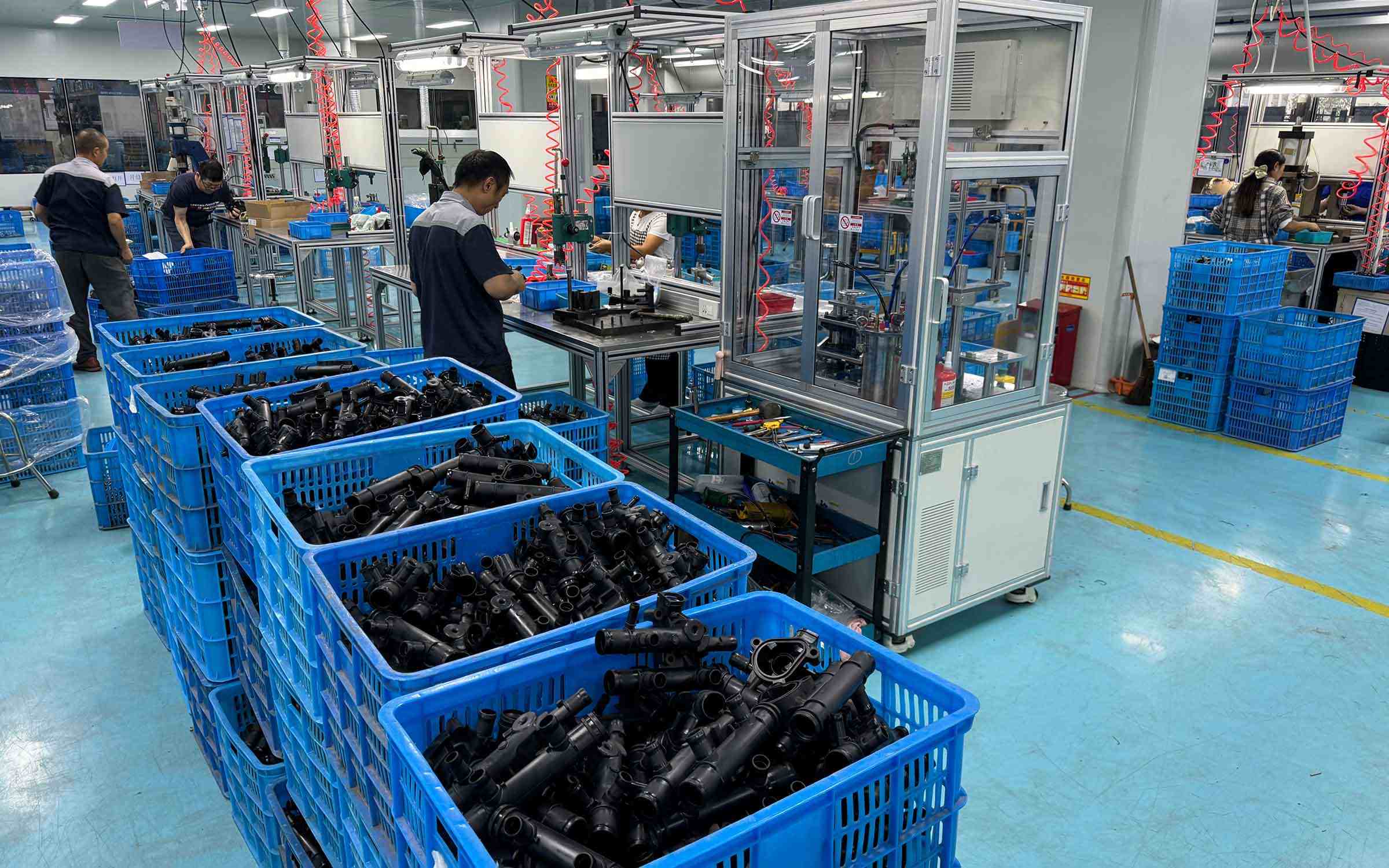 Skilled workers assembling engine thermostats at Elecdura