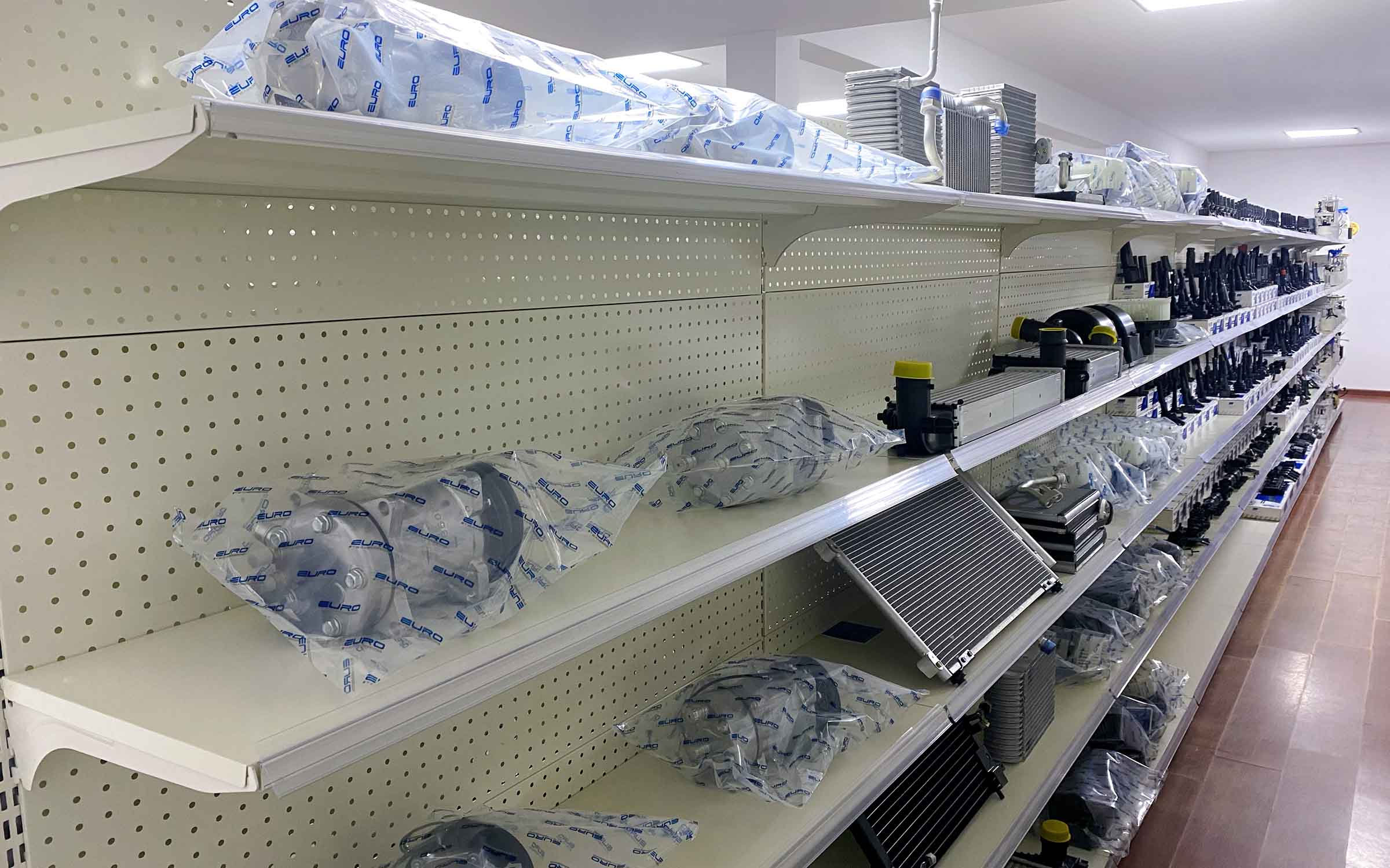 Display racks showcasing AC compressors for wholesale partner presentation