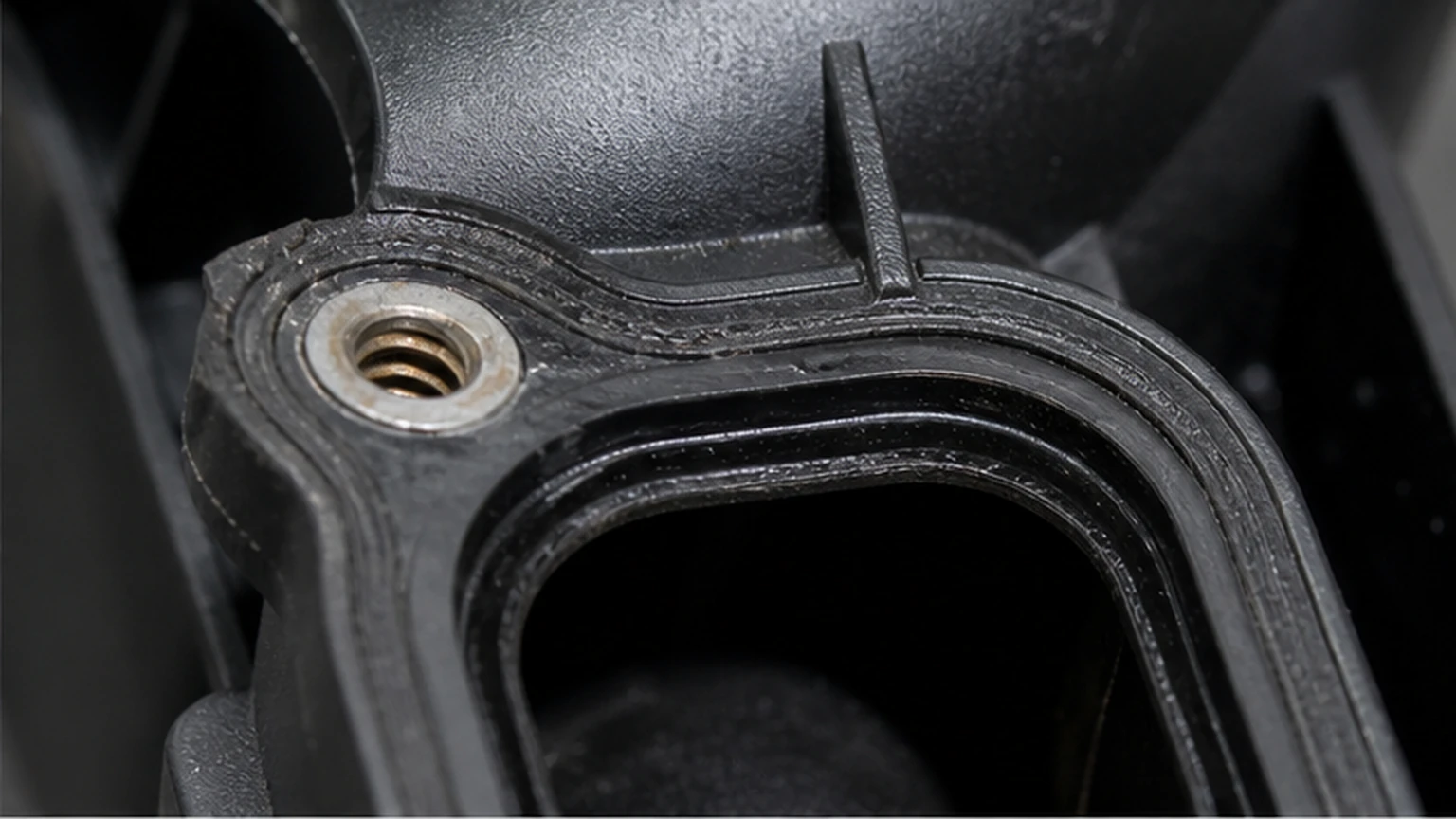 Plastic intake manifold bolt boss, metal insert and gasket groove inspected for distortion and uneven compression