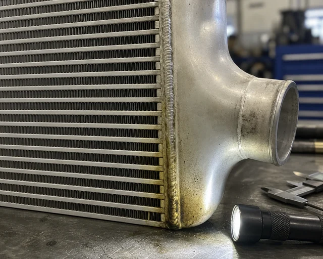 Charge air cooler tank seam and fin inspection with light oil residue trace
