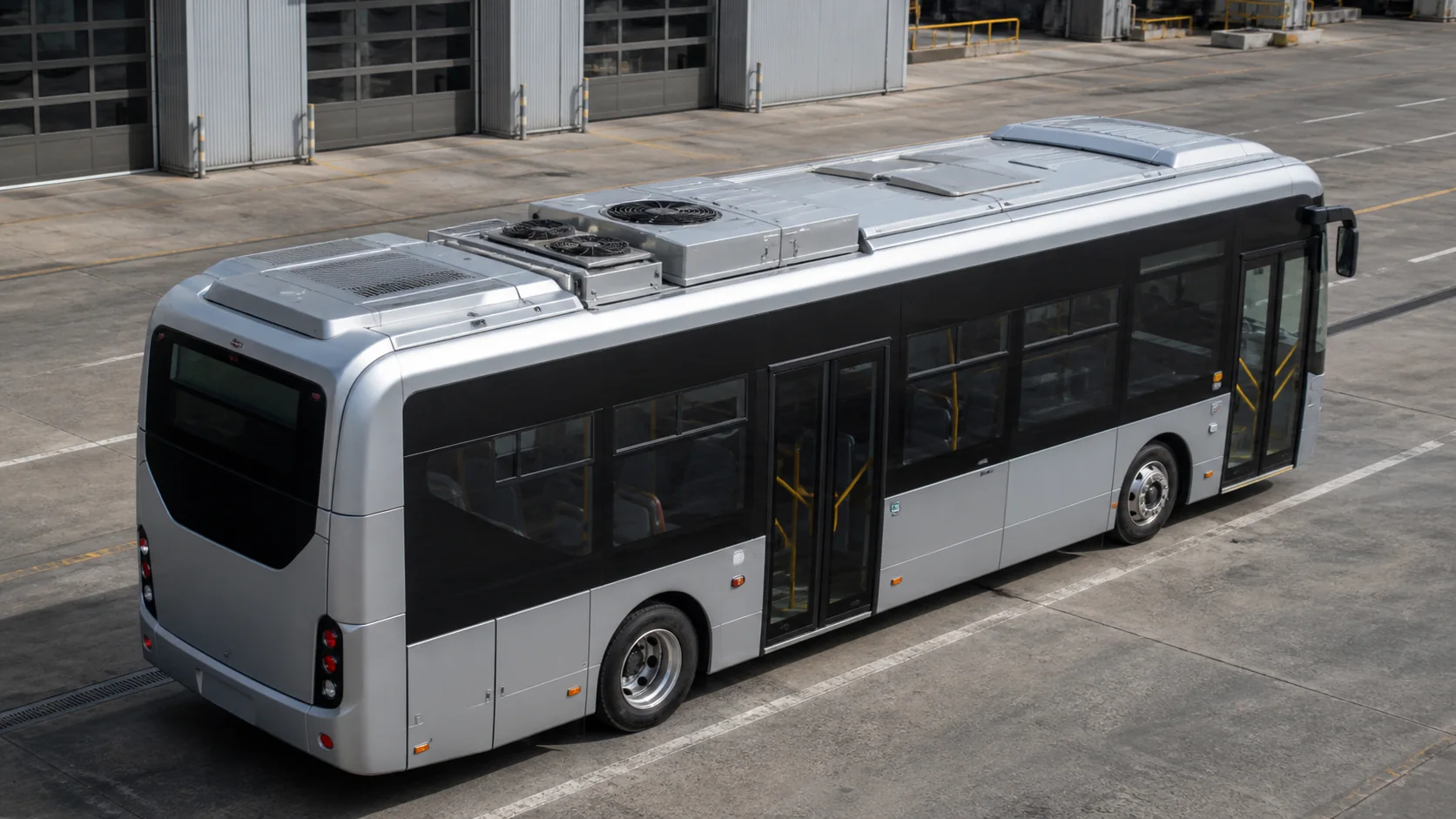 Electric city bus with rooftop HVAC module in a maintenance depot