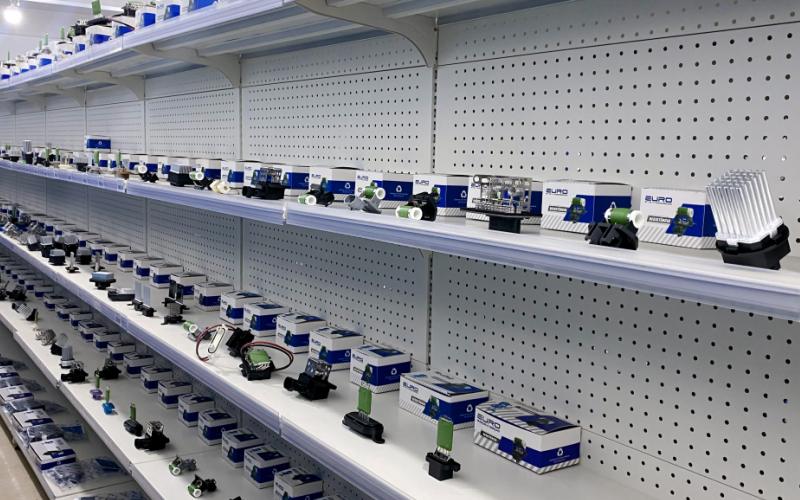 Extensive warehouse display of blower motor resistors and automotive electrical components for global distribution.