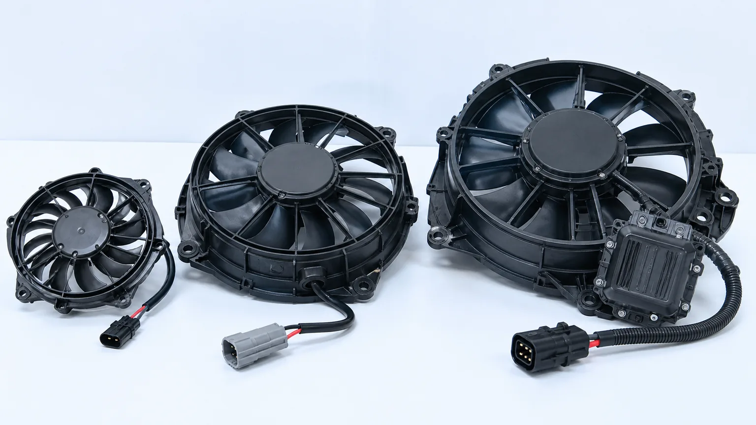 12 volt, 24 volt, and 48 volt brushless vehicle cooling fan assemblies arranged for technical comparison