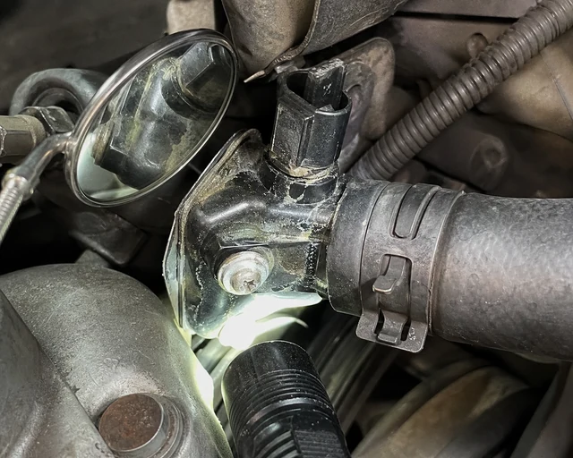 Engine bay thermostat housing leak check around hose outlet and sensor port
