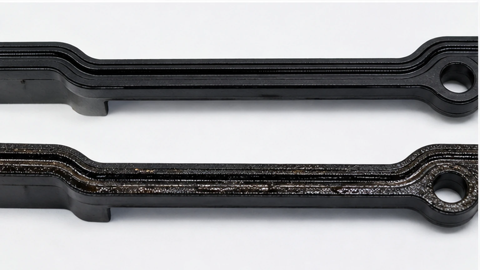 Uniform and uneven valve cover gasket compression patterns compared on a plastic sealing groove